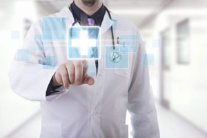 Doctor in a Hospital Hallway Wearing a Lab Coat and Stethoscope Taps Virtual Icons With Health Symbols