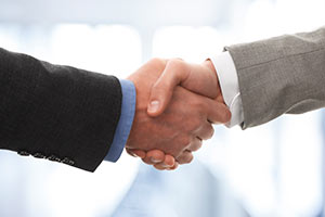 Close Shot of Two Men in Suits Shaking Hands