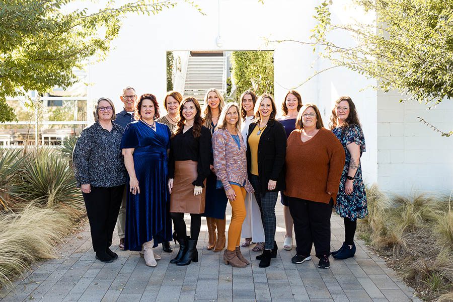 Meet Our Team - ECI Insurance Group Standing Together and Smiling for a Photo Outside on a Beautiful Day