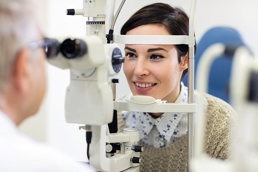 Individual-Vision-Insurance-Optometrist-Examining-the-Eyesight-of-a-Woman-Patient
